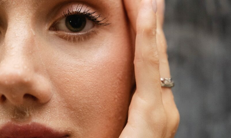 a close up of a person with a ring on her finger
